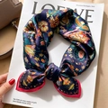 Navy blue silk scarf with vintage floral print and pink rolled edges on magazine - Gorgeous Money Tree