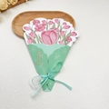Top view of a pink tulip bouquet greeting card with mint green packaging and satin ribbon - Tulip