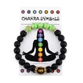 Detail of chakra stone bracelet on a white meditation card with colorful energy symbols - Turquoise + Lava Stone