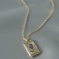 Vintage gold tarot card necklace featuring The Lovers design on an elegant silk background - Gold Lovers