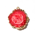 Detail view of a red agate pendant with gold plated edges and natural crystal textures - Red