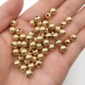 High-gloss golden round CCB spacer beads for DIY jewelry making held in hand - KC Gold Beads (14079)