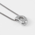 Polished silver bubble-style letter pendant on a minimalist stainless steel chain - Steel Letter D