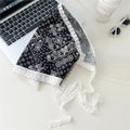 Flat lay of black paisley bandana with white lace edges and long straps for hair styling - Vintage Black Paisley