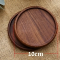 Pair of circular black walnut wood coasters with 10cm diameter on rustic linen background - Black Walnut Round Grooved 10cm
