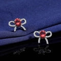 Elegant bow stud earrings with oval red gemstone and pavé diamonds in silver - Red Diamond Bow Earrings Led-137