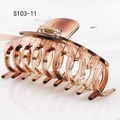 Detail of tortoiseshell large claw clip featuring a golden spring and sturdy grip - Transparent Tortoiseshell