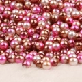 Lustrous mixed pink and beige round no-hole faux pearls on soft white plush background - Gold Deep Pink