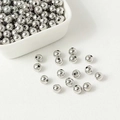 Polished silver metal round beads for jewelry making displayed in a white bowl - Platinum Plated