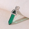 Green crystal hexagonal column pendant necklace with silver metal clasp on beige fabric - Green Crystal