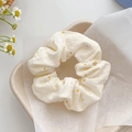Cream mesh scrunchie with daisy print on a neutral background for summer hairstyles - Beige Floral