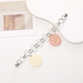 Detailed shot of double chain bracelet with smiley face charms and magnetic clasps - K907-Smiley Face Bracelet