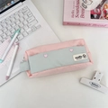 Close-up of pastel pink and blue canvas pencil case with heart studs and woven label - Light Pink