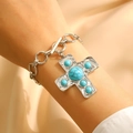 Close-up of silver chain bracelet with turquoise cross pendant and T-bar clasp on wrist - Silver Turquoise Bracelet (X313)