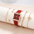Square gold watch with red faux leather strap and four matching gold bracelets on stand - Watch + Bracelet Set / Red