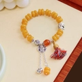 Ethnic yellow agate bead bracelet with silver charm and colorful tassel on wooden tray - Round Brand Colored Tassel Imitation Amber Bracelet