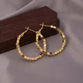 Chic golden hoop earrings with small linked cubes for a modern minimalist fashion look - E-057---gold 30mm