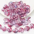 Macro view of purple gradient star and moon glass beads with golden glitter for DIY jewelry - Plum Purple Gold Sprinkled