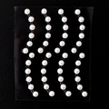 Self-adhesive white pearl stickers for eye makeup and face decoration on black background - MX-31 White Curved Pearl