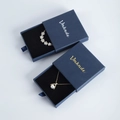 Navy blue drawer jewelry gift box with black velvet lining and elegant gold logo - Blue