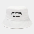 Close-up of LOVE STORY EST 1989 embroidery on a white cotton bucket hat - One Size / White
