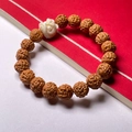 Rudraksha seed bracelet with white lion head bead on a red and white background - Toad Back 8-10mm (Awakened Lion)