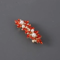 Close-up of golden hair clip with red leaf-shaped crystals and white pearls decoration - Red with Gold Base