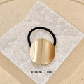 Punk style geometric hair clip with gold metal disc on black elastic band - Round