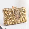 Detail of champagne gold evening clutch featuring sunflower rhinestone patterns and metal clasp - Gold