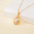 Gold stainless steel necklace featuring a shell pearl in an oval textured pendant - Wavy Texture Oval Pearl Style (137530)