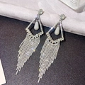 Macro view of long silver tassel earrings featuring rhinestone fringe and teardrop pendant - Silver Rhombus Frame Teardrop Tassel (467)