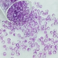 Detailed view of purple crackle glass beads scattering on a white velvet surface - 6mm / Purple