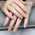 Macro shot of glossy almond-shaped nails with elegant nude pink gradient finish - By1663 Fairy-like Beauty / Glue Type