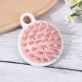 Pink silicone scalp massager brush with white base on natural wood surface - Japanese Style White+Pink