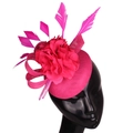 Elegant rose red sinamay fascinator hat with mesh flower and feathers on a mannequin - Rose Red