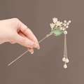Detail of a golden lily of the valley hair pin with white flowers and elegant tassels - Lily of the Valley Glaze