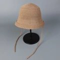 Detail showing soft knit texture and long ribbon ties of the camel bucket hat - M (56-58cm) / Khaki