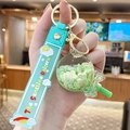 Light green candy-shaped keychain with floral clay slices and a silicone strap - Flower Lollipop - Green