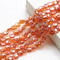 Macro shot of iridescent 12mm rhombus glass beads in orange and amber for DIY crafts - Wine Red Plated