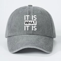 Close-up of gray washed cotton baseball cap with IT IS WHAT IT IS printed text design - One Size(Adjustable) / Washed Grey