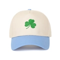 Close-up of four-leaf clover embroidery on a color-block five-panel baseball cap - Beige Crown + Light Blue Brim