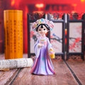 Detail of a resin girl figurine in purple ancient dress with a flower basket - Medium Size Flower Basket