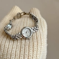 Vintage silver women's watch with mother of pearl dial and geometric link strap on sweater - Silver