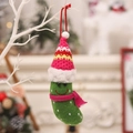 Creative Christmas tree ornament featuring a green pickle figurine wearing a festive red hat - Pink Scarf Style