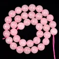 Strand of translucent pink quartz beads for DIY jewelry making on black background - Natural Rose Quartz / 4mm/1 Piece Approximately 90 Pieces/10g