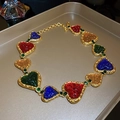 Macro detail of vintage heart necklace featuring colorful enamel inlay and gold-tone metal - 83# Necklace Emerald Rhinestone Colorful Pleated Heart