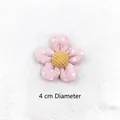 Close-up of pink polka dot fabric flower with yellow corduroy center 4cm diameter - Pink Polka Dot Flower
