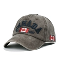Detailed close-up of blue CANADA embroidery and flag patch on washed cotton baseball cap - Coffee