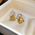 Detailed close-up of 18k gold plated flower earrings with pearls and zircons in a gift box - Flower Petal Pearl Rhinestone Style