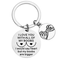 Detailed close-up of engraved silver keychain with humorous text and round charm - Boobs Bigger Humorous Style